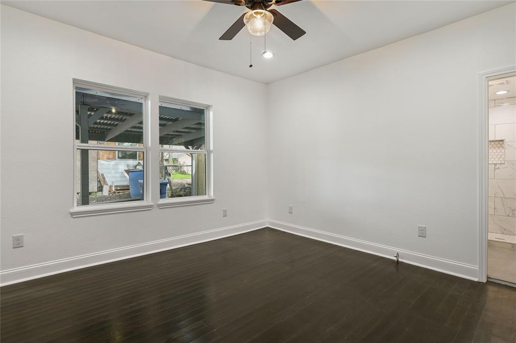 1106 West Chestnut Street Denison, TX 75020 - Photo 17 of 29 an empty room with a window and a ceiling fan