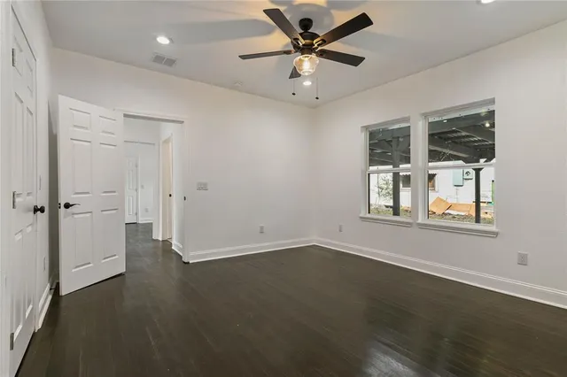 an empty room with a empty space and windows