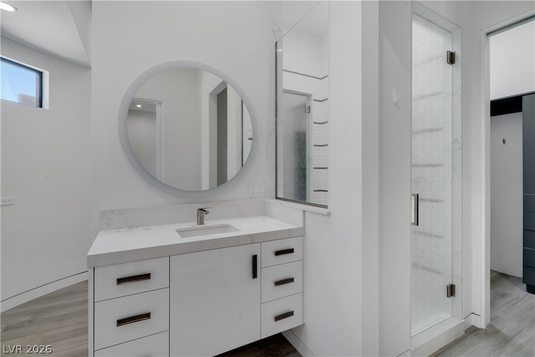 10 Ridge Blossom Road Las Vegas, NV 89135 - Photo 29 of 64 Full bathroom with light wood finished floors, vanity, and a stall shower