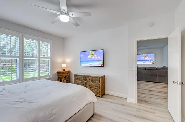 a front door view of a bathroom with a sink and a mirror