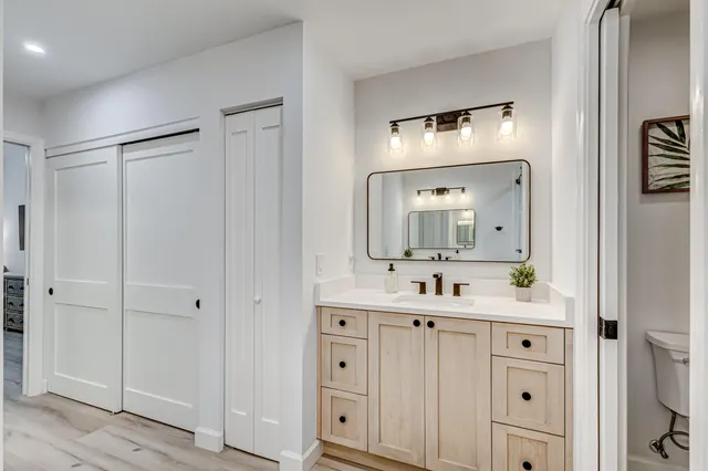 a en suite bathroom with a double vanity sink a mirror and shower