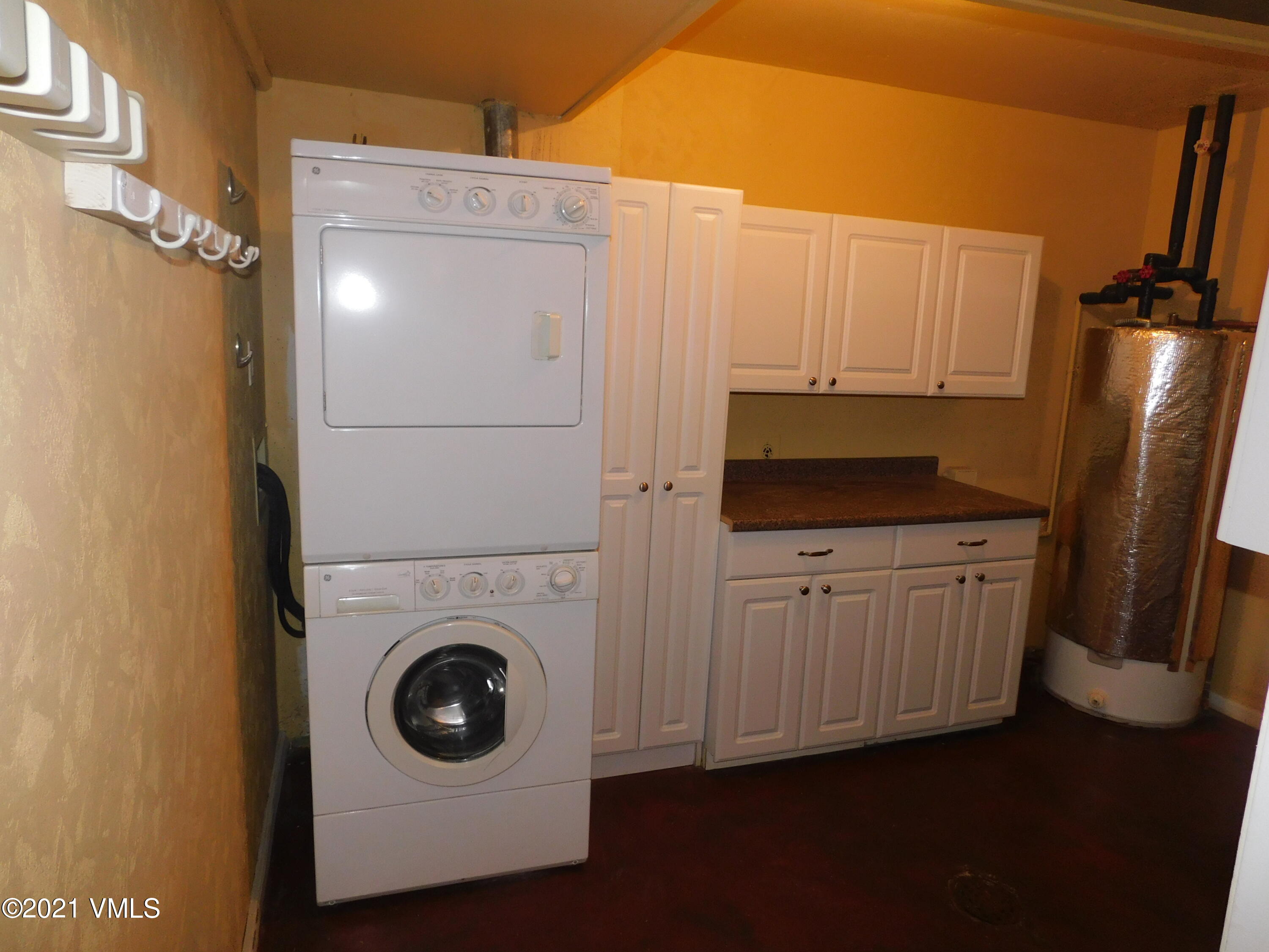 230 Nottingham Road, Unit A Avon, CO 81620 - Photo 11 of 12 a kitchen with white cabinets and white appliances