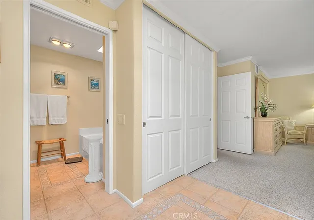 a bedroom with a bed a mirror and furniture