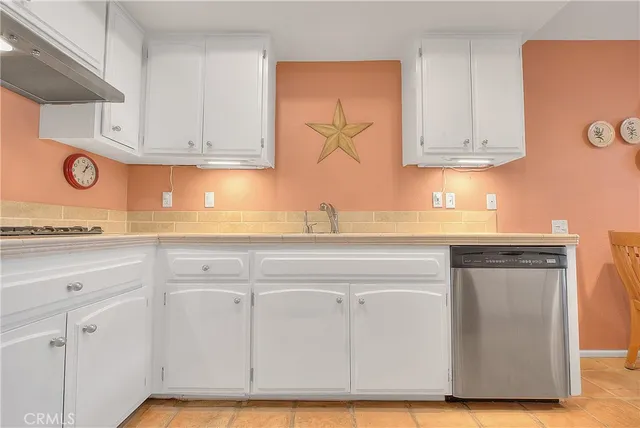 a kitchen with stainless steel appliances granite countertop a sink and a stove