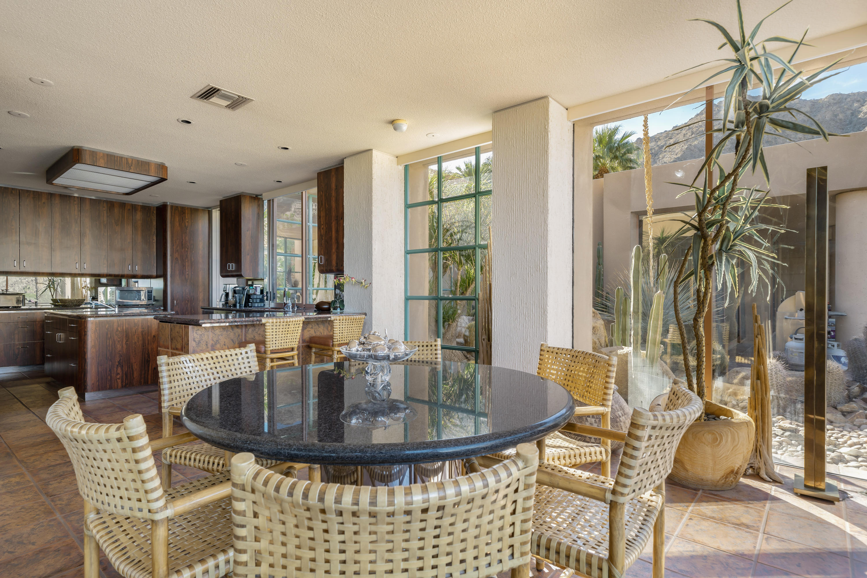 75270 Hidden Cove Indian Wells, CA 92210 - Photo 17 of 73 a view of a dining room with furniture and a floor to ceiling window