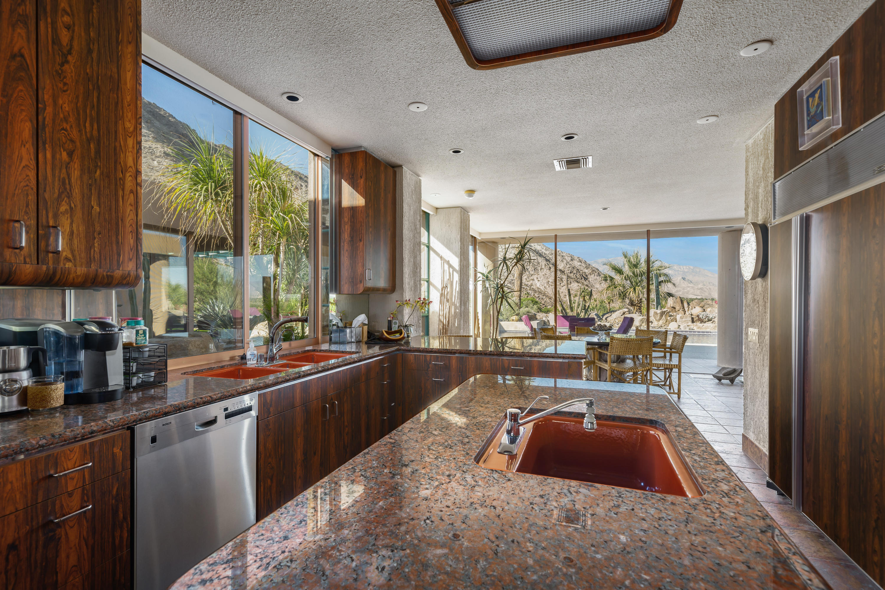 75270 Hidden Cove Indian Wells, CA 92210 - Photo 27 of 73 a large white kitchen with a large window and stainless steel appliances