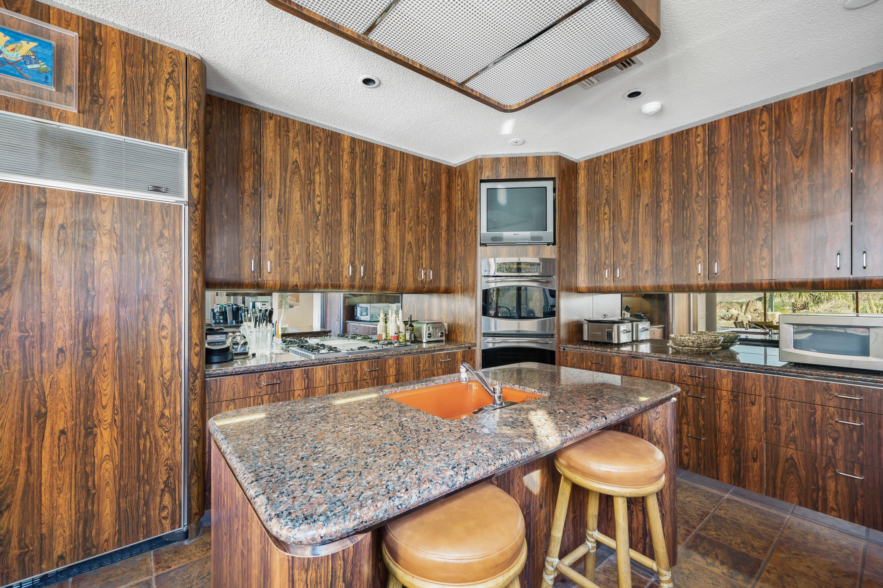 75270 Hidden Cove Indian Wells, CA 92210 - Photo 30 of 73 a kitchen with stainless steel appliances granite countertop a sink counter space and a window