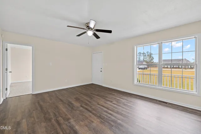a view of a kitchen with wooden floor and a ceiling fan