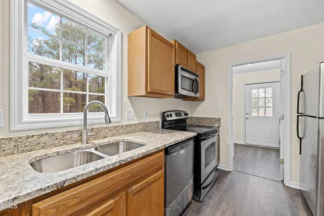 a kitchen with a stove top oven sink and cabinets