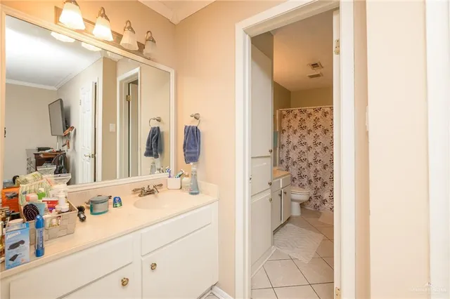 a en suite bathroom with a double vanity sink mirror and shower