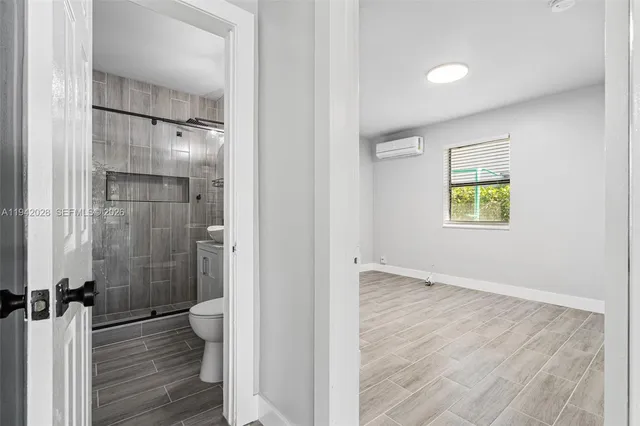 a bathroom with a sink and a glass door shower