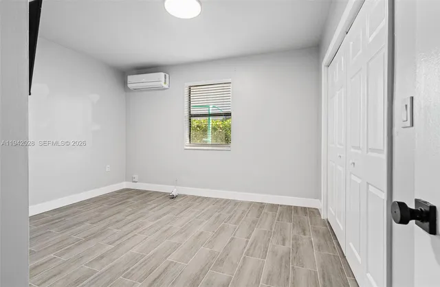 wooden floor in an empty room with a window