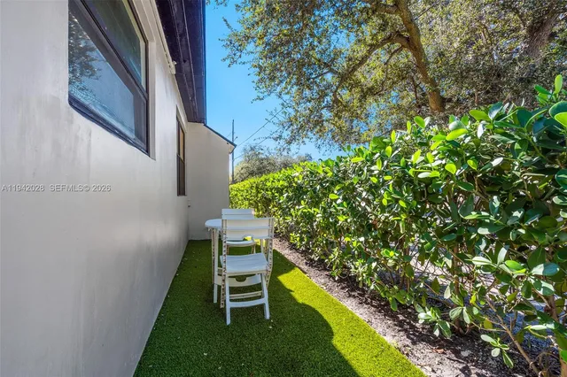 a view of a yard with a large tree