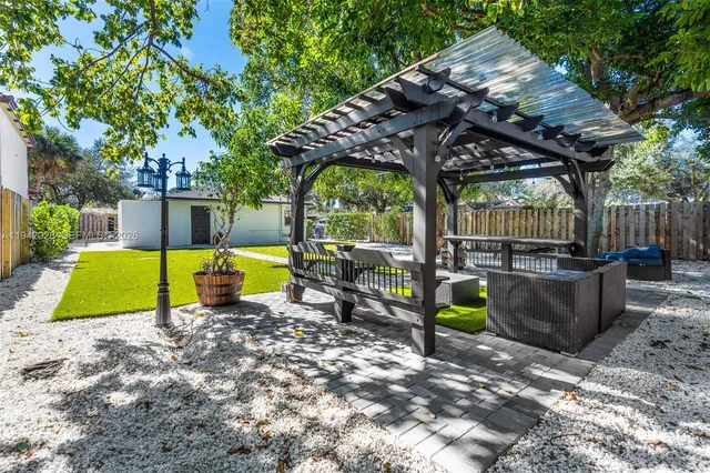 a bathroom with a toilet a sink a mirror a vanity and shower
