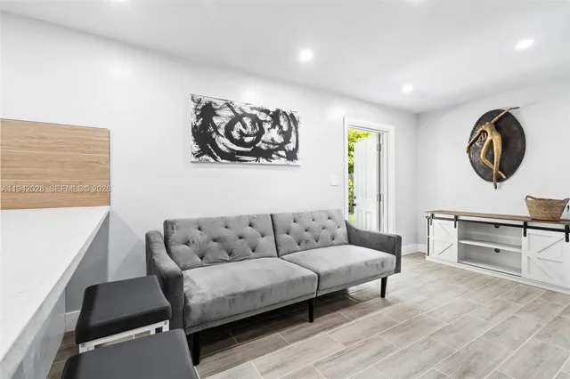 a living room with a couch a table and a large window