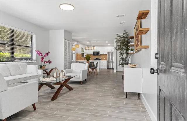 a living room with furniture and wooden floor