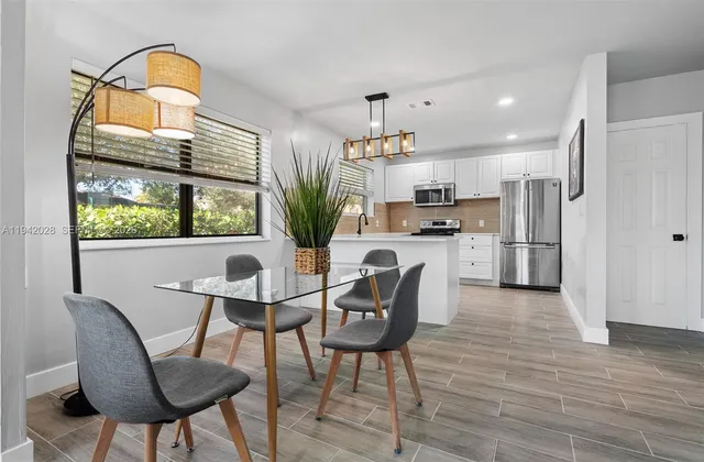 a view of a dining room with furniture and a potted plant