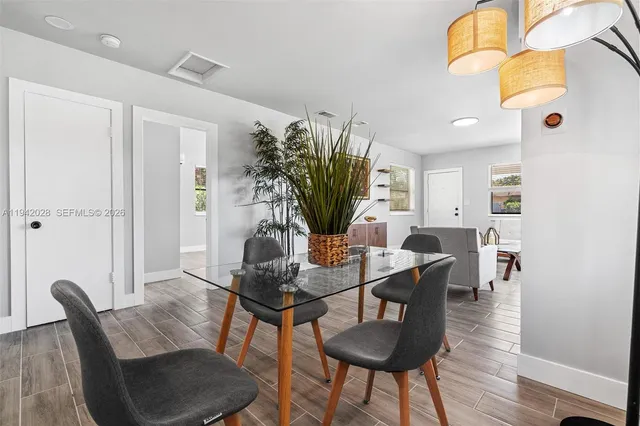 a dining room with furniture and wooden floor