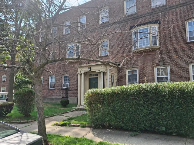 a front view of a building with garden