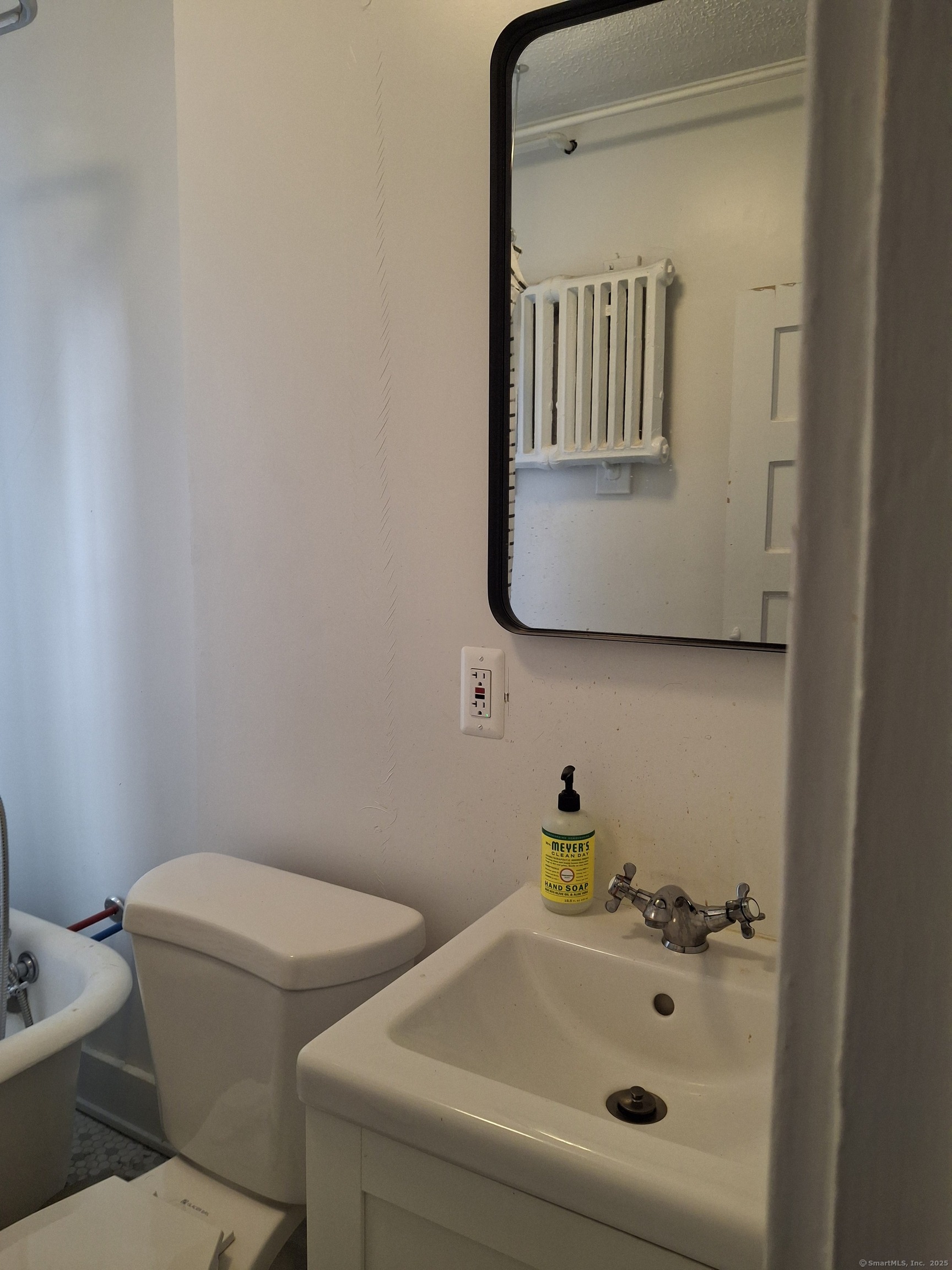591 Wilmot Avenue, Unit 3 Bridgeport, CT 06607 - Photo 15 of 16 a bathroom with a sink and a mirror
