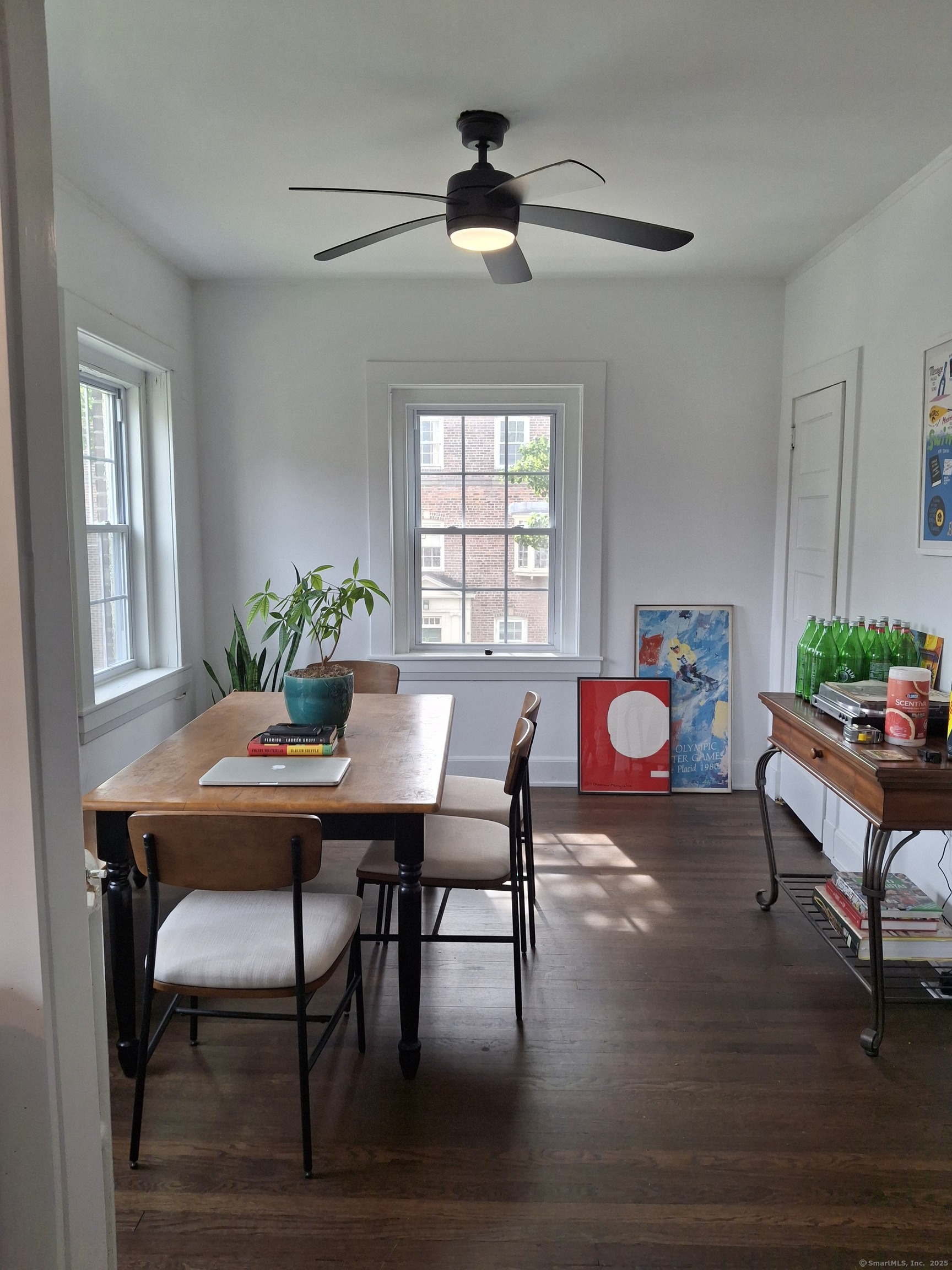 591 Wilmot Avenue, Unit 3 Bridgeport, CT 06607 - Photo 2 of 16 a dining room with furniture a rug a chandelier and wooden floor