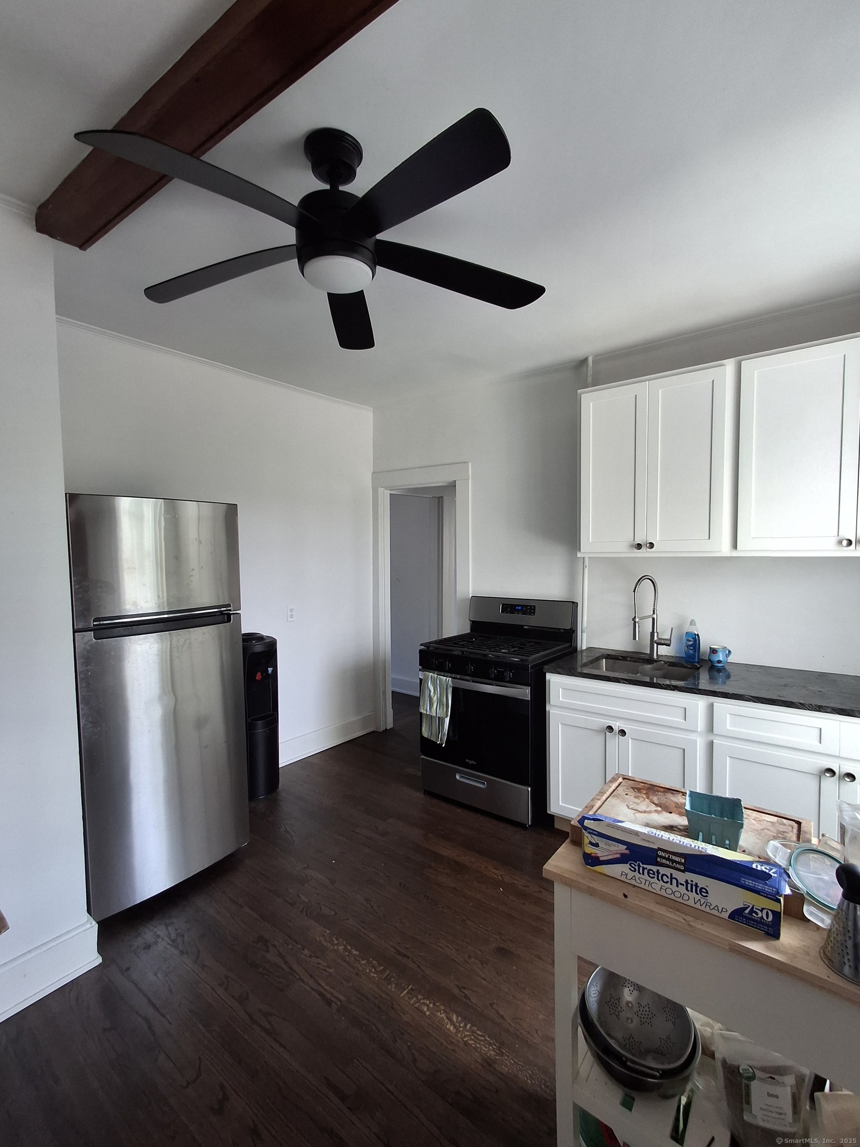 591 Wilmot Avenue, Unit 3 Bridgeport, CT 06607 - Photo 6 of 16 a kitchen with granite countertop a refrigerator and a stove top oven
