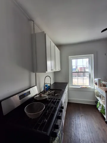 a kitchen with a sink stove and cabinets