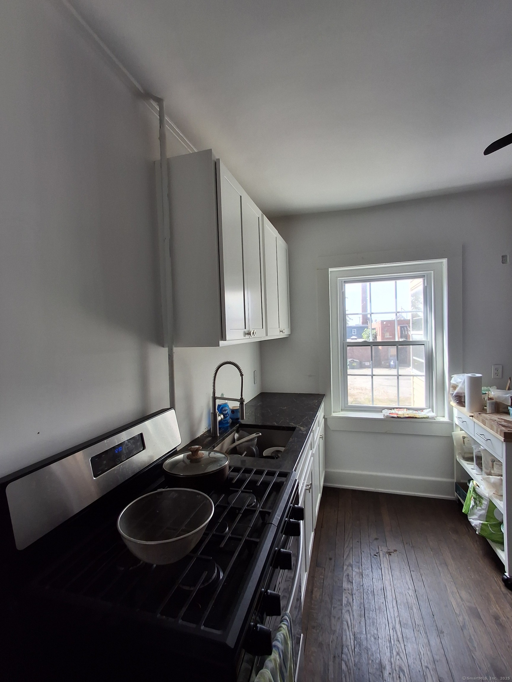 591 Wilmot Avenue, Unit 3 Bridgeport, CT 06607 - Photo 7 of 16 a kitchen with a sink stove and cabinets