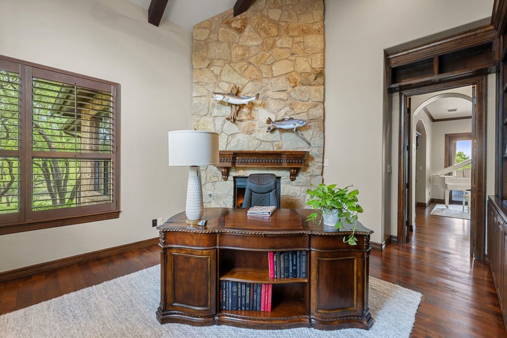 1540 County Road 262 Georgetown, TX 78633 - Photo 10 of 40 The grand study features a stone fireplace, wall-to-wall custom built-ins, and soaring beamed ceilings that give the room the gravitas of a private library.