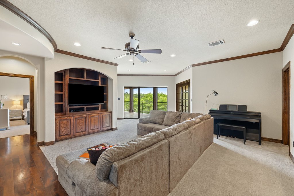 1540 County Road 262 Georgetown, TX 78633 - Photo 17 of 40 A built-in entertainment center anchors the room, while private veranda access seamlessly connects you to the serene natural surroundings.