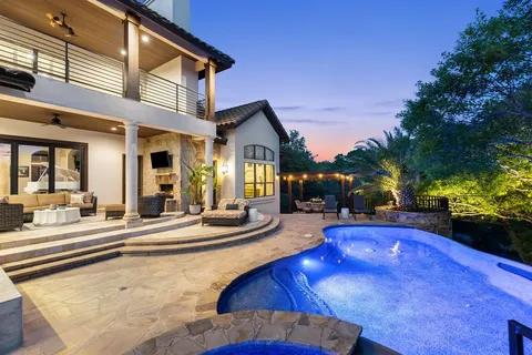 a view of a house with swimming pool and sitting area
