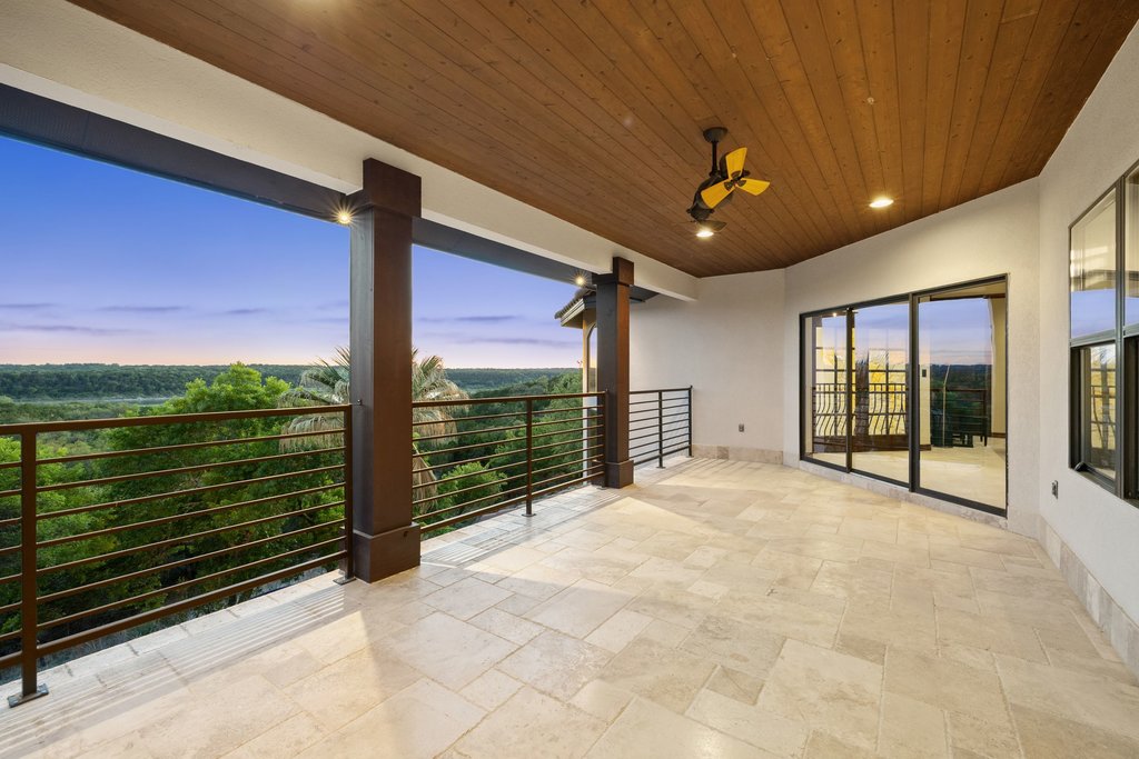 1540 County Road 262 Georgetown, TX 78633 - Photo 28 of 40 Upstairs, a large covered veranda extends the living area outdoors, offering a front-row seat to the night sky above the Hill Country and the glittering pool deck below.