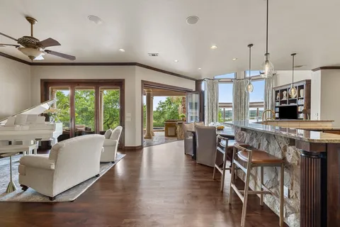 a living room with furniture a flat screen tv and a large window
