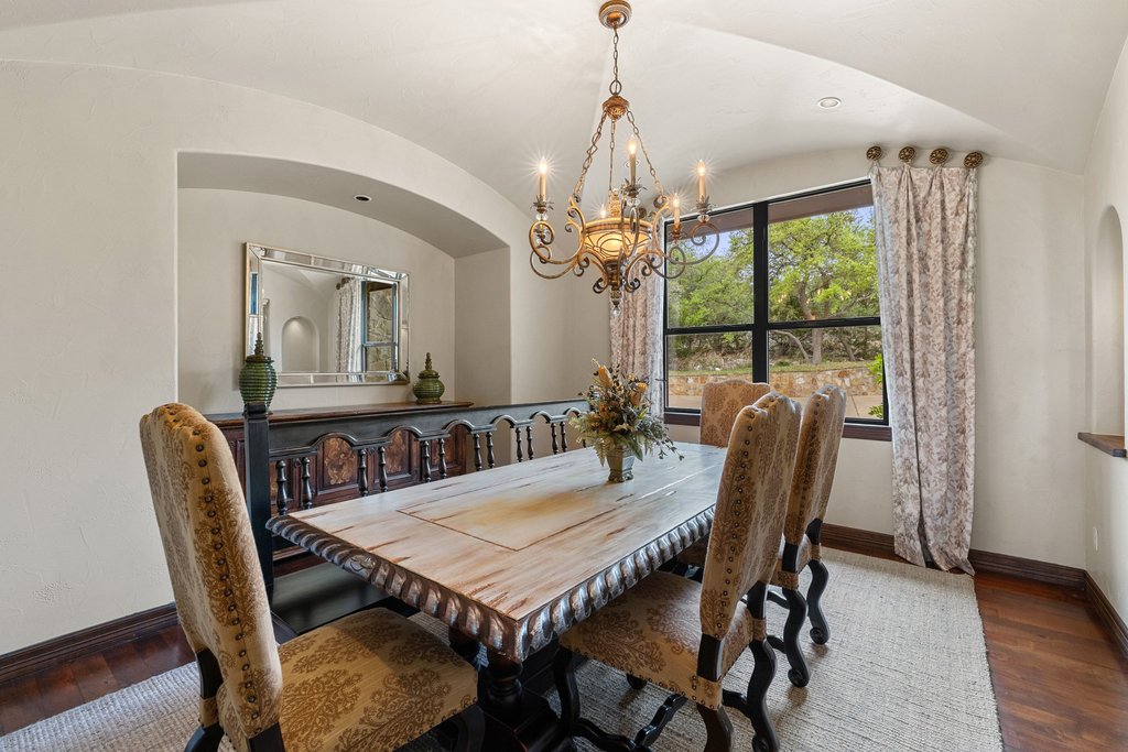 1540 County Road 262 Georgetown, TX 78633 - Photo 32 of 40 The formal dining room, flooded with natural light, is elegantly centered around a timeless chandelier.