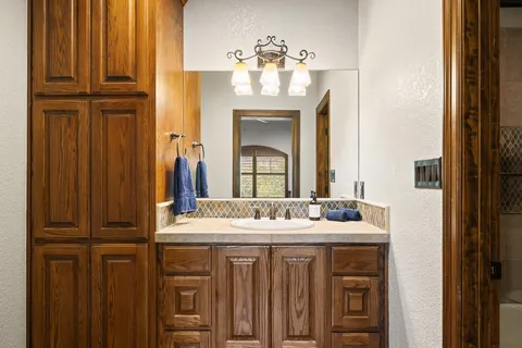 a bathroom with a sink vanity and a mirror