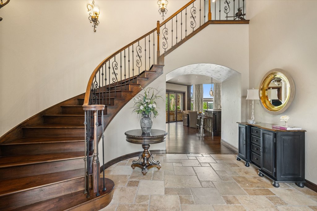 1540 County Road 262 Georgetown, TX 78633 - Photo 9 of 40 Step inside and the home unfolds with intention, beginning with a grand foyer featuring a curved staircase and elegant, soaring ceilings.
