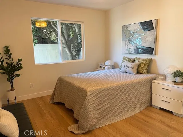 a bedroom with a bed and a painting on the wall