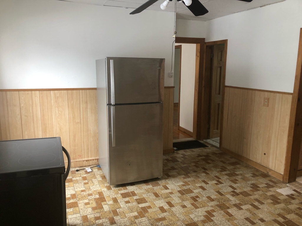 21 Whipple Street, Unit 3 Worcester, MA 01607 - Photo 1 of 8 a view of a refrigerator in kitchen and an empty room