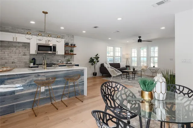 a kitchen with a table chairs stove and cabinets
