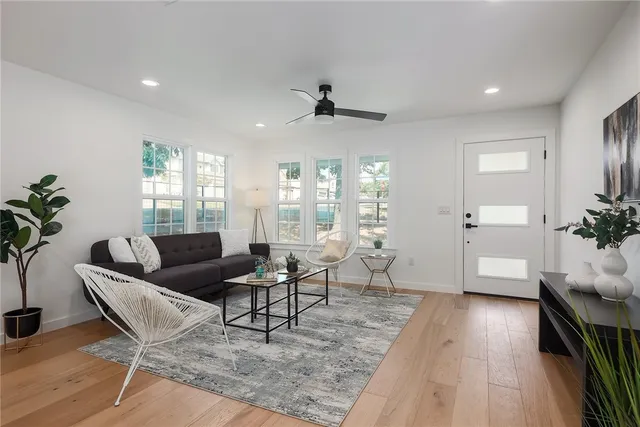 a living room with furniture and wooden floor