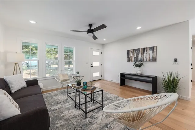 a living room with furniture and a potted plant
