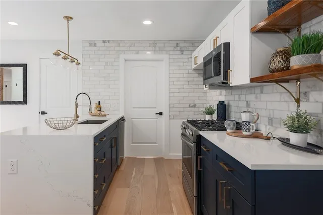 a kitchen with stainless steel appliances a sink stove top oven and microwave