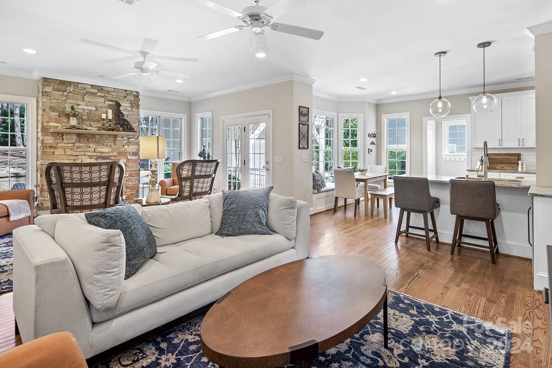 544 Ashby Drive Davidson, NC 28036 - Photo 16 of 40 a living room with fireplace furniture and a wooden floor
