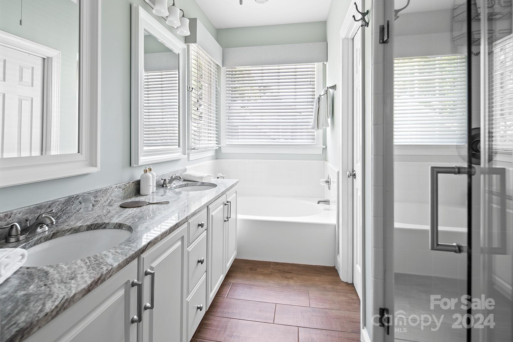 544 Ashby Drive Davidson, NC 28036 - Photo 23 of 40 a bathroom with a granite countertop sink and a bathtub