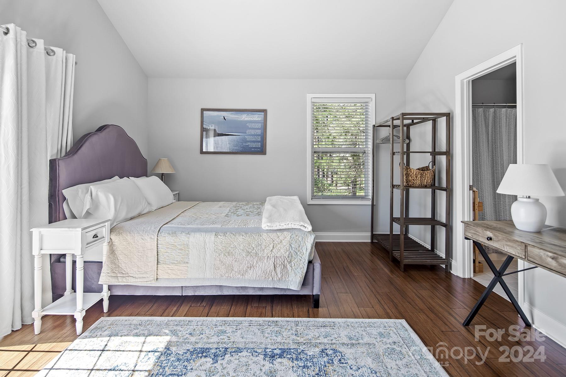 544 Ashby Drive Davidson, NC 28036 - Photo 32 of 40 a bedroom with a bed a dresser and wooden floor