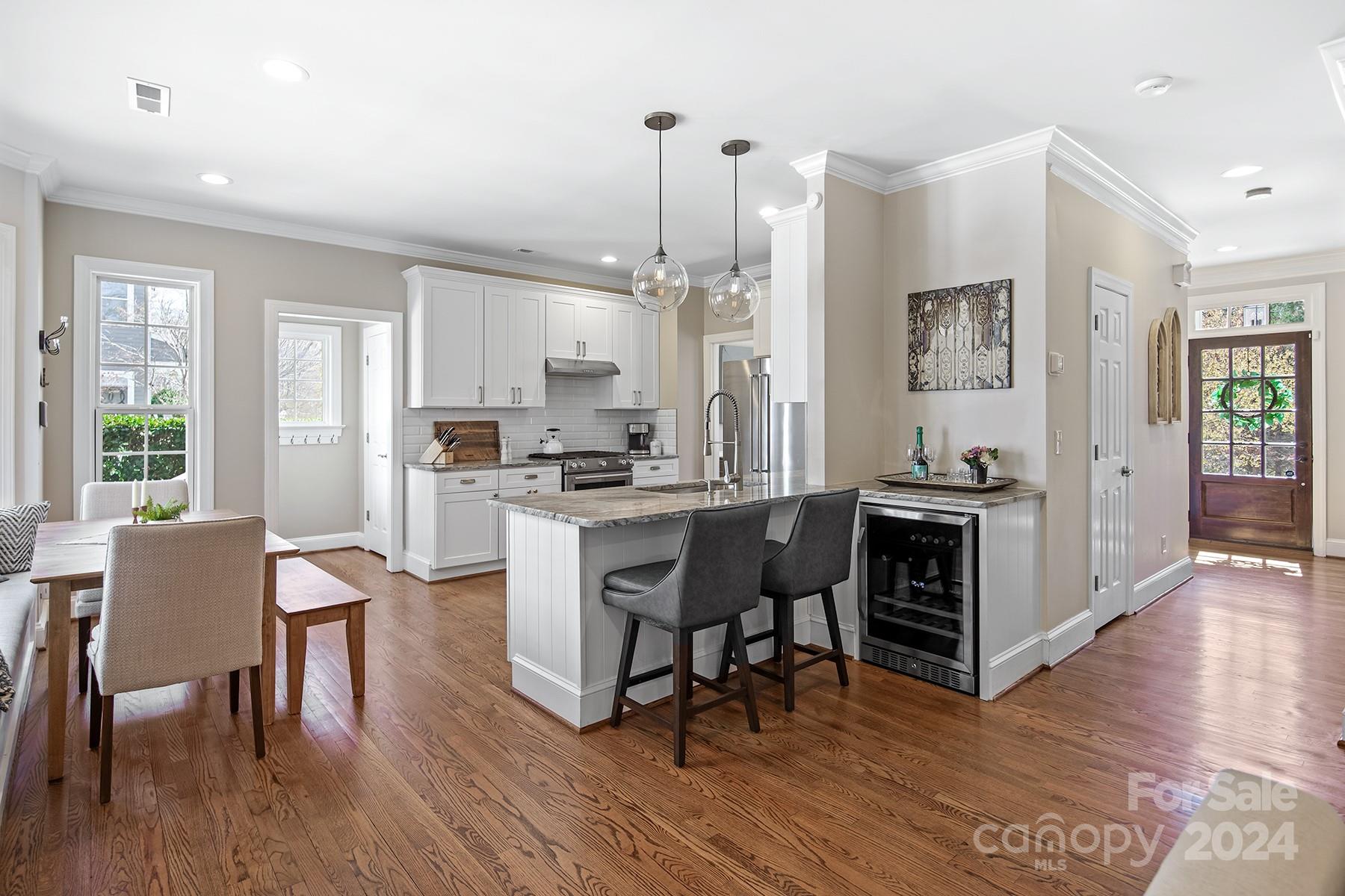 544 Ashby Drive Davidson, NC 28036 - Photo 8 of 40 a kitchen with stainless steel appliances granite countertop a stove a sink a refrigerator dining table and chairs