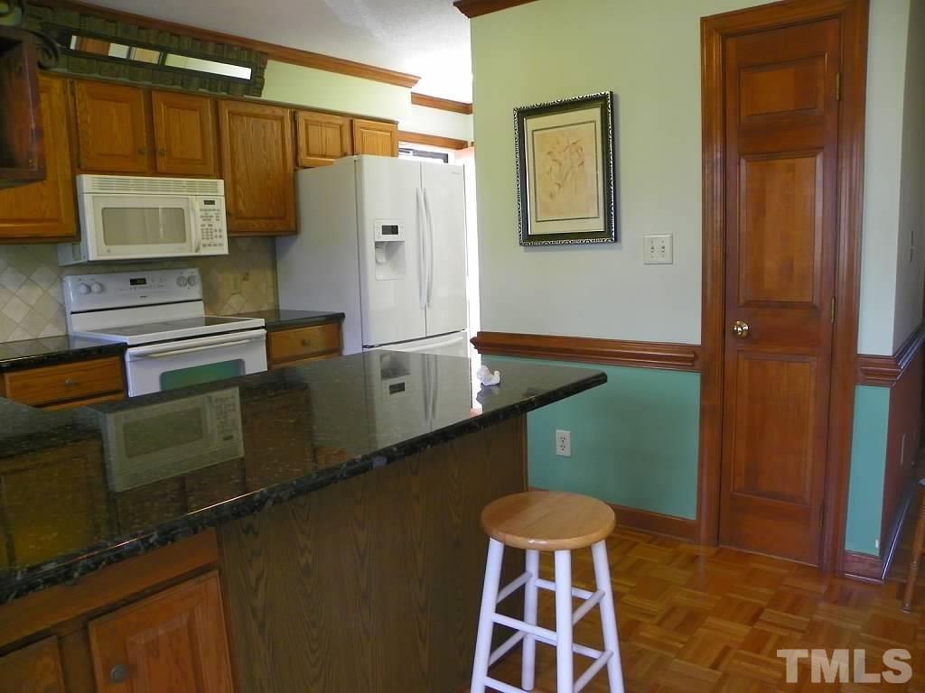 409 South Meadow Road Raleigh, NC 27603 - Photo 5 of 25 Don't miss the breakfast bar feature in the kitchen or the pantry right across from it.