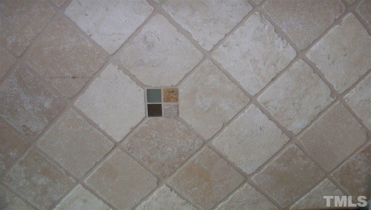 409 South Meadow Road Raleigh, NC 27603 - Photo 7 of 25 Sometimes....it's the little things that matter. This is the upscale tile used around the backsplash in the kitchen.