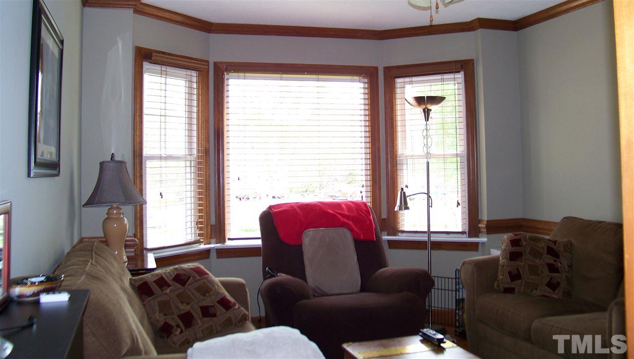 409 South Meadow Road Raleigh, NC 27603 - Photo 8 of 25 Currently, the owners are using this dining room as a den. It would make a great formal dining room with its gleaming parque hardwood floors, chair rail, crown molding, and bay window.
