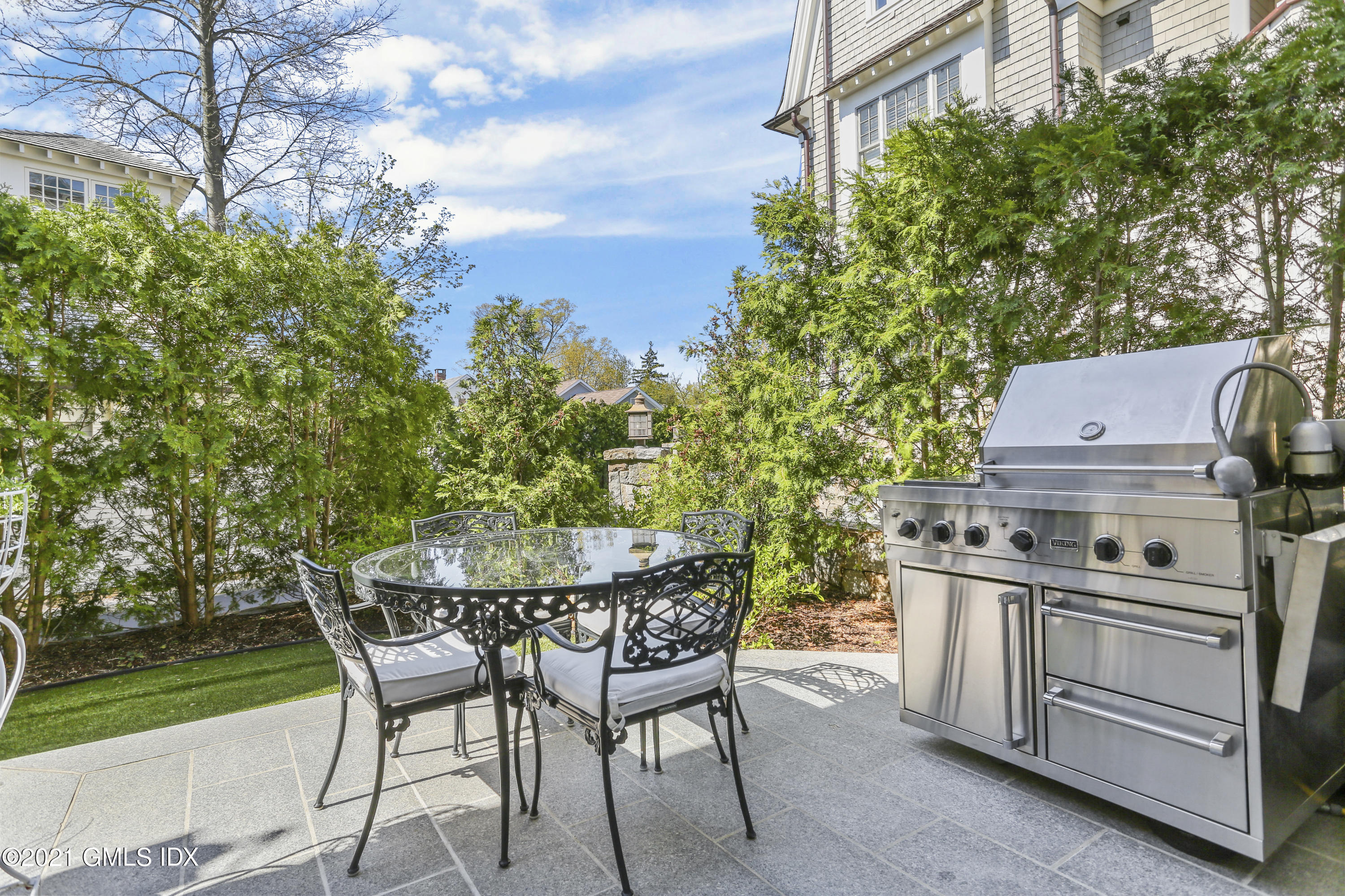 50 Sound View Drive, Unit 2 SOUTH Greenwich, CT 06830 - Photo 13 of 21 a view of a chairs and table in the backyard